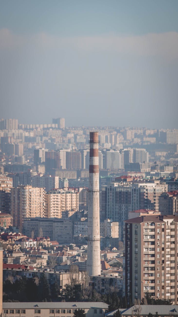 cityscape with a view of an industrial chimney