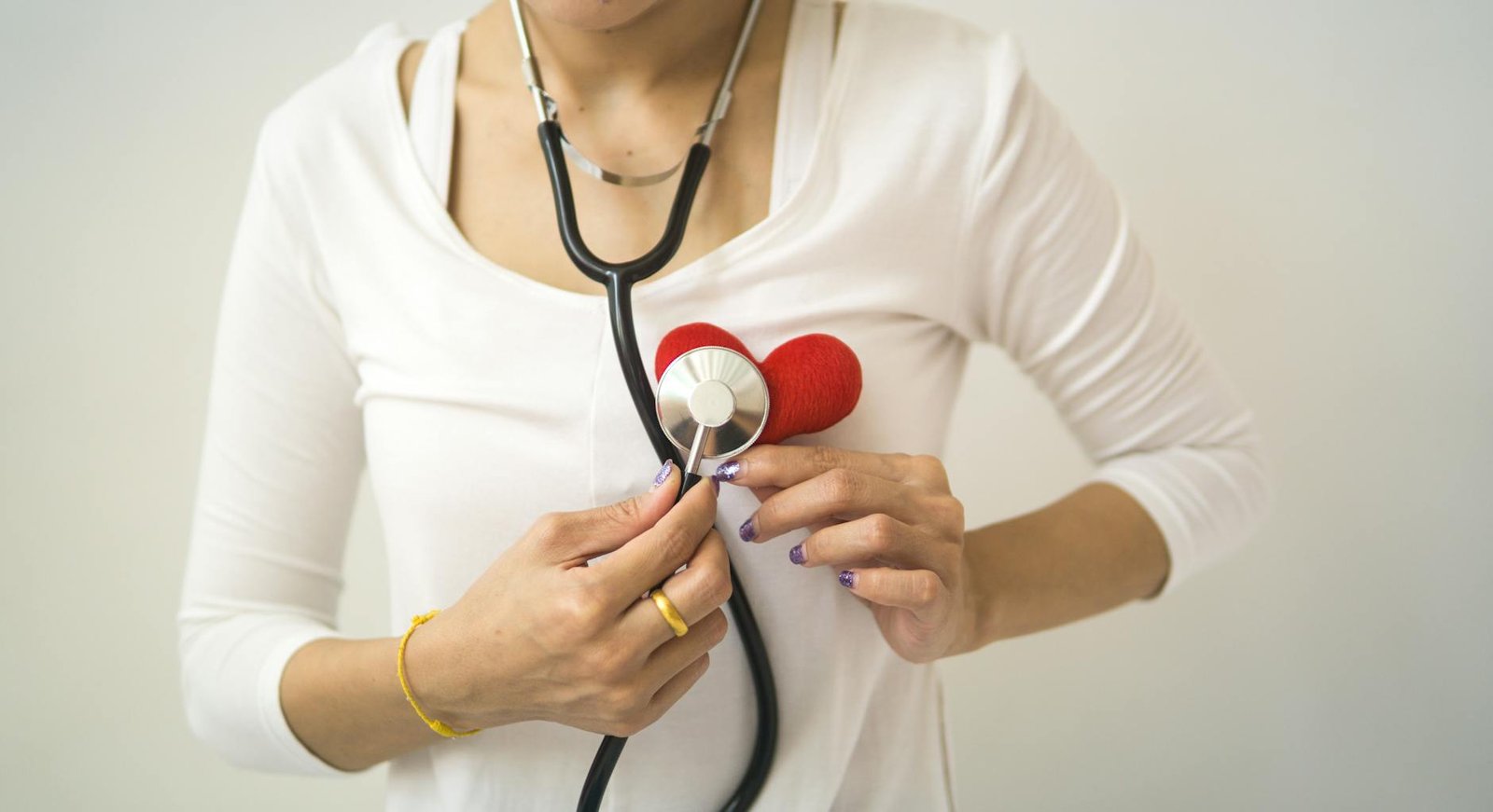 crop woman with stethoscope on neck