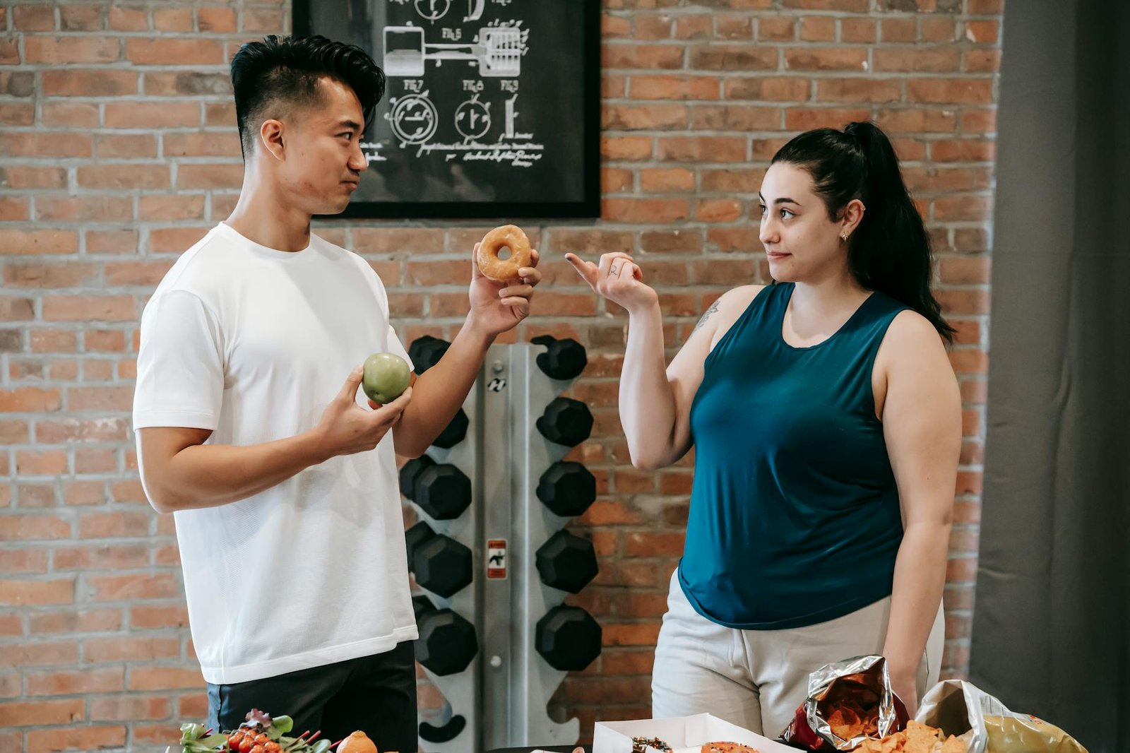 personal trainer showing food options to a woman