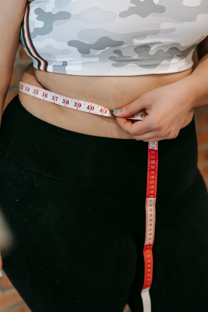 woman measuring her waist